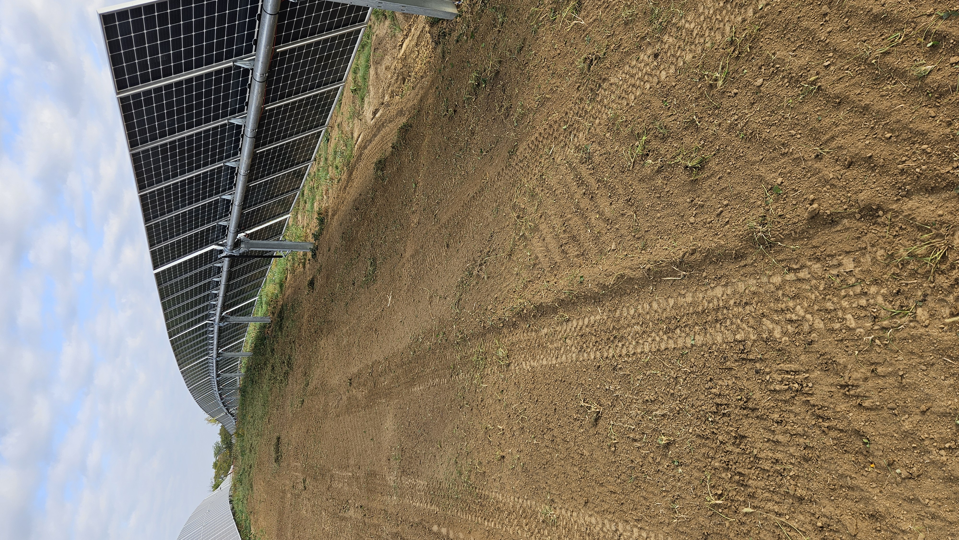 Restored and stabilized soil grade beneath panels